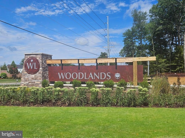 community sign featuring a lawn