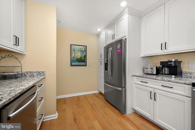 kitchen featuring recessed lighting, white cabinets, stainless steel appliances, and light wood-style floors