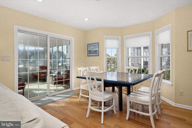 dining room featuring recessed lighting, baseboards, and light wood-style floors