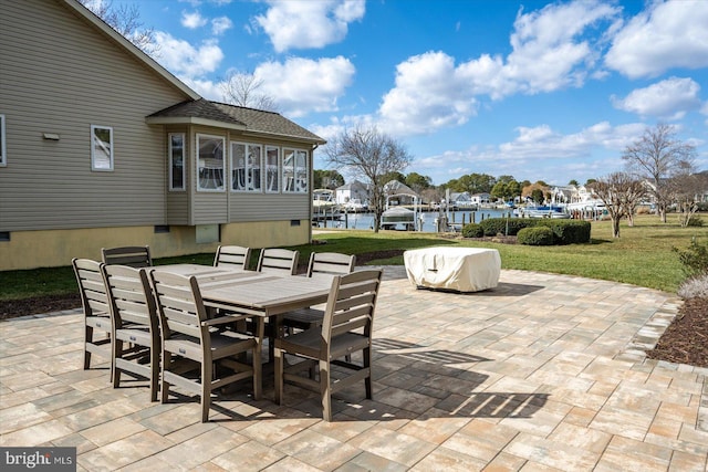 view of patio / terrace featuring outdoor dining area, a water view, and a residential view