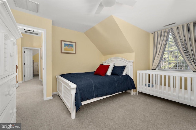 bedroom with baseboards, visible vents, carpet floors, and lofted ceiling