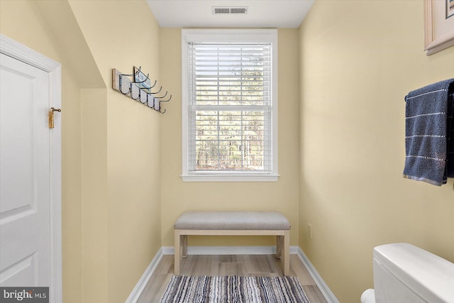 bathroom with visible vents, toilet, baseboards, and wood finished floors