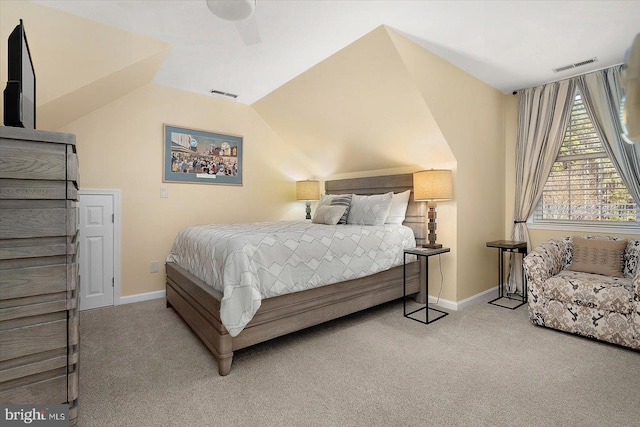 carpeted bedroom with visible vents, lofted ceiling, and baseboards