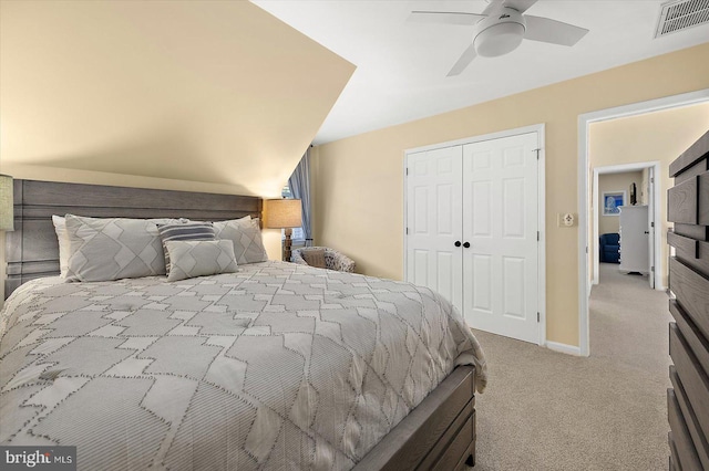 carpeted bedroom with a closet, visible vents, a ceiling fan, and baseboards