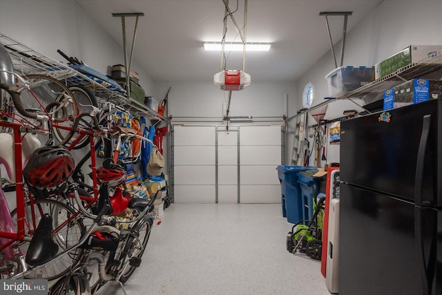 garage featuring a garage door opener, freestanding refrigerator, and bike storage