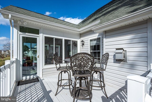 wooden terrace featuring outdoor dining space