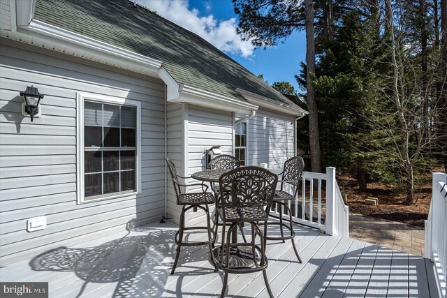 wooden terrace with outdoor dining area