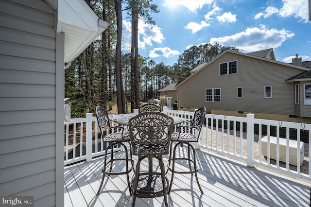 wooden terrace with outdoor dining space