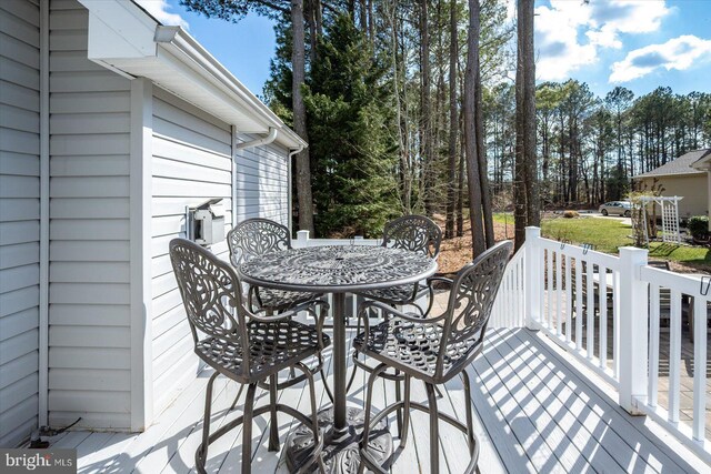 deck with outdoor dining area