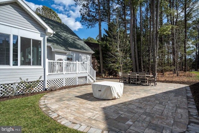 view of patio / terrace featuring outdoor dining space and a wooden deck