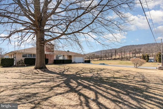 exterior space featuring a mountain view and an attached garage