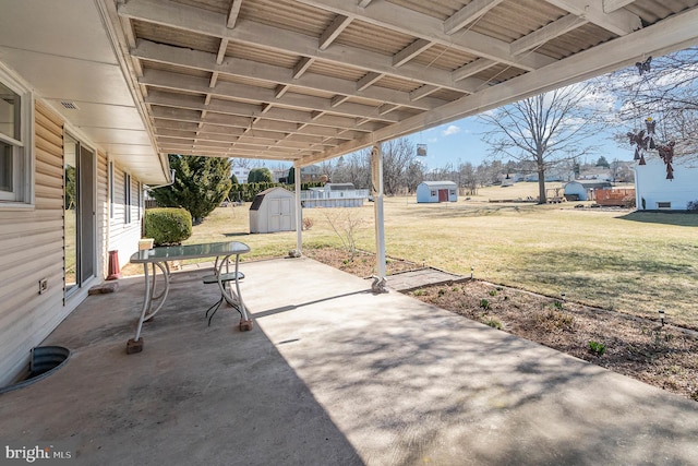 view of patio with a storage unit and an outdoor structure