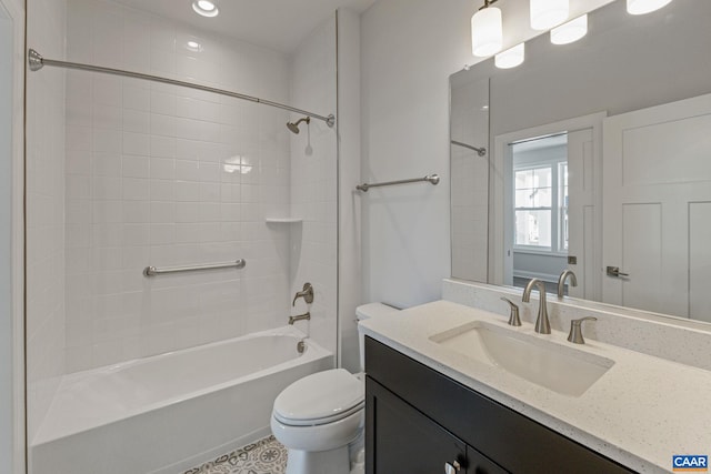 bathroom featuring toilet, vanity, and bathtub / shower combination