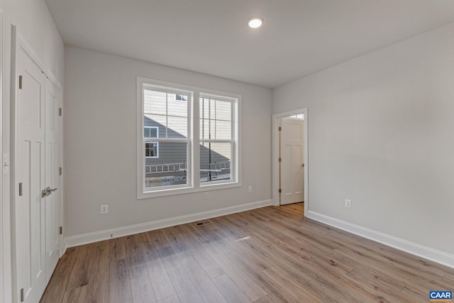 unfurnished bedroom featuring baseboards and light wood finished floors