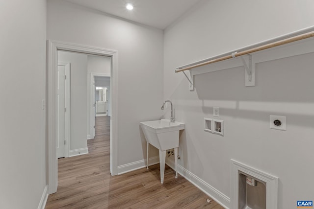 washroom featuring baseboards, laundry area, electric dryer hookup, washer hookup, and light wood-type flooring