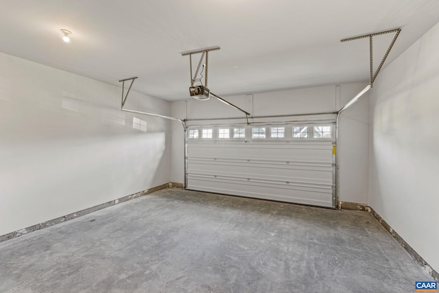 garage with a garage door opener and baseboards