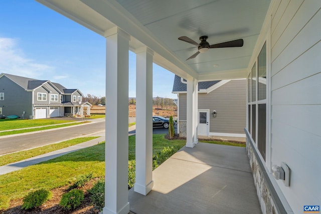 view of patio with a residential view, a porch, and ceiling fan