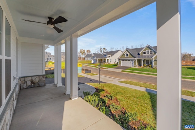 view of patio / terrace featuring a porch, a ceiling fan, and a residential view