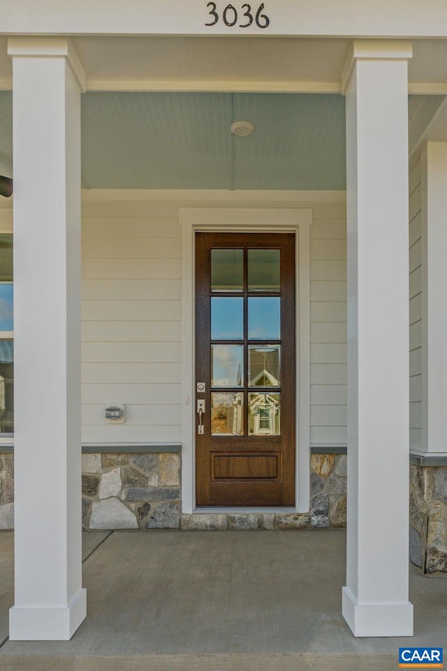 view of exterior entry featuring stone siding