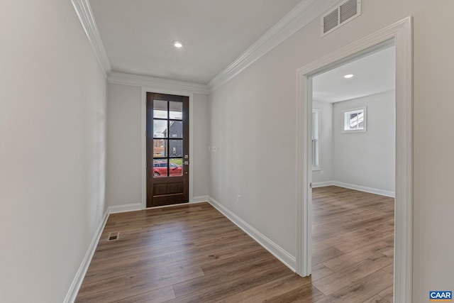 entrance foyer featuring crown molding, wood finished floors, and visible vents