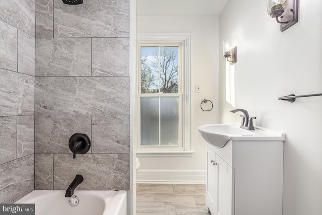 full bath featuring shower / bathing tub combination, baseboards, and vanity