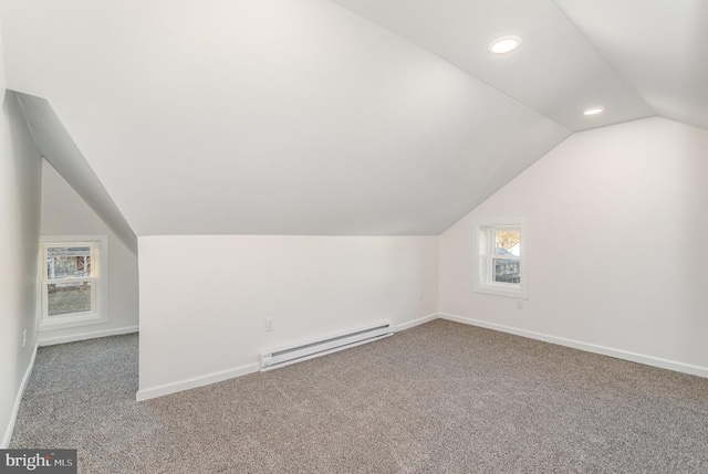 additional living space featuring lofted ceiling, a baseboard heating unit, recessed lighting, carpet flooring, and baseboards