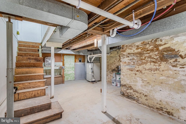 unfinished basement featuring stairs and heating unit