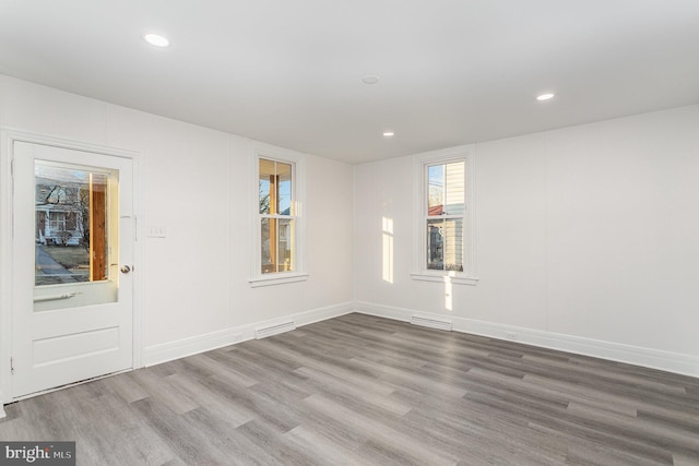 spare room featuring recessed lighting, visible vents, and wood finished floors