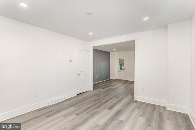 empty room with visible vents, recessed lighting, baseboards, and light wood-style floors