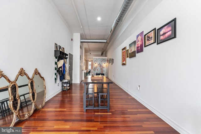 hallway with baseboards and wood finished floors