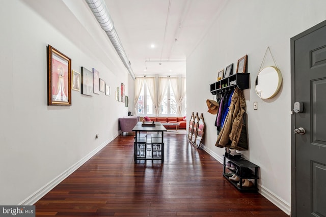 dining room featuring track lighting, baseboards, and wood-type flooring