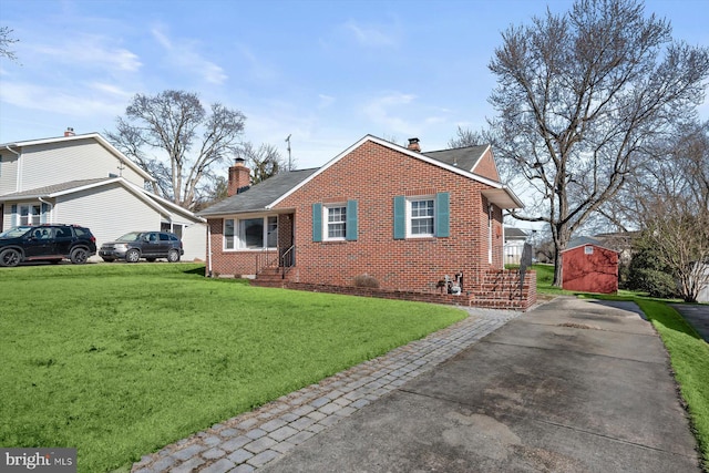 exterior space with brick siding, a lawn, and a chimney