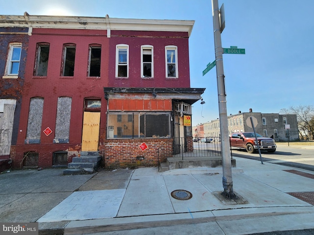 view of property with entry steps and brick siding