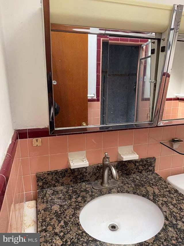 bathroom featuring tile walls and vanity