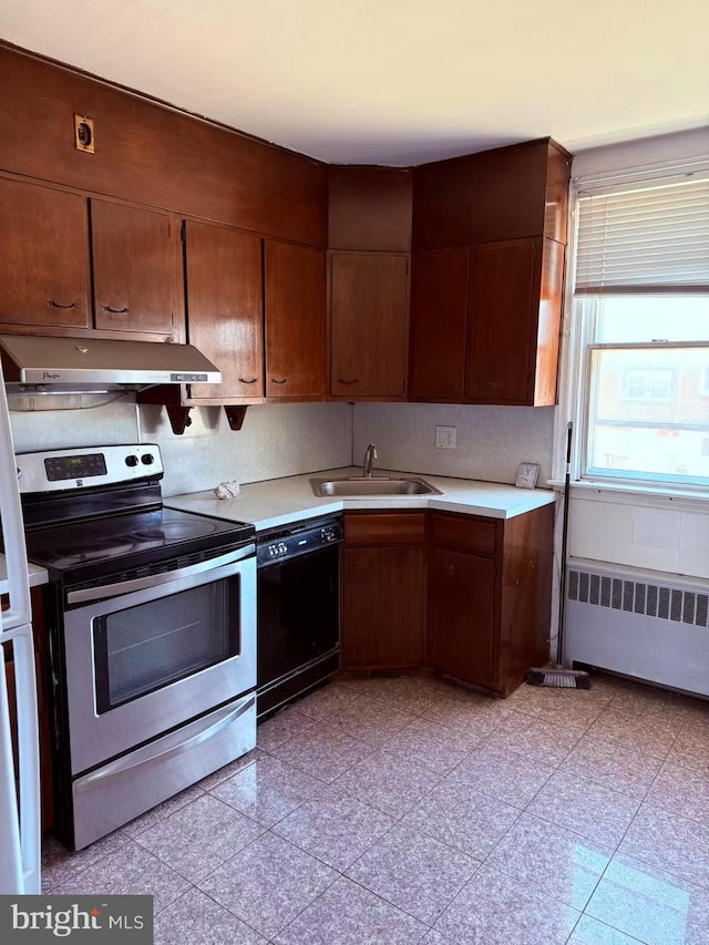 kitchen with stainless steel range with electric stovetop, under cabinet range hood, a sink, black dishwasher, and radiator heating unit