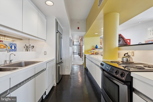 kitchen featuring a sink, stainless steel appliances, white cabinets, and light countertops