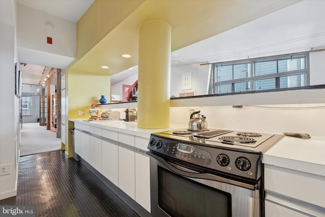 kitchen with stainless steel electric range oven, white cabinets, plenty of natural light, and light countertops