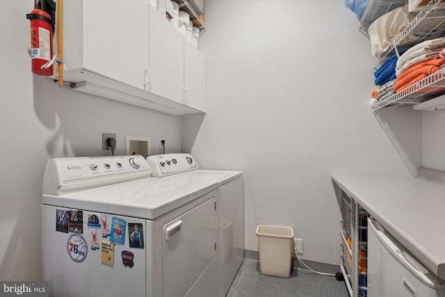 laundry area featuring washing machine and dryer and cabinet space