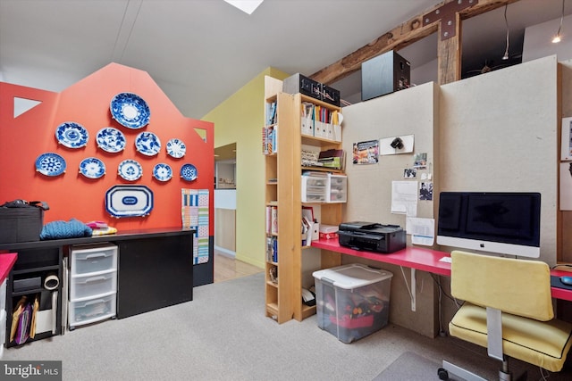 carpeted home office with vaulted ceiling