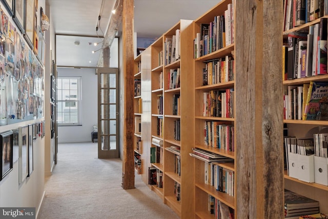 hall featuring carpet and french doors