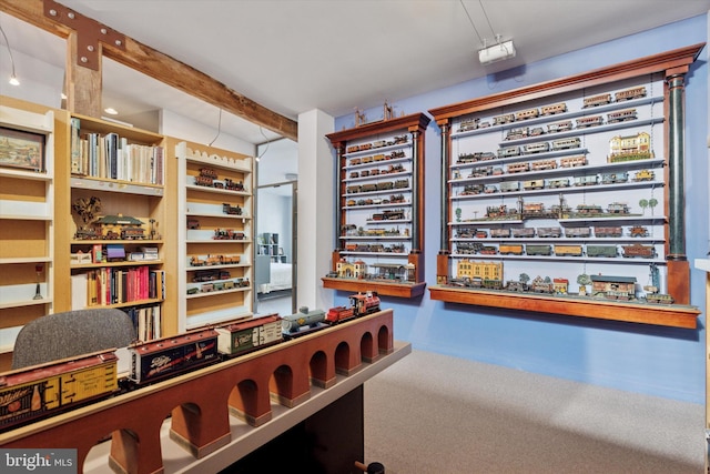 interior space featuring beam ceiling and carpet