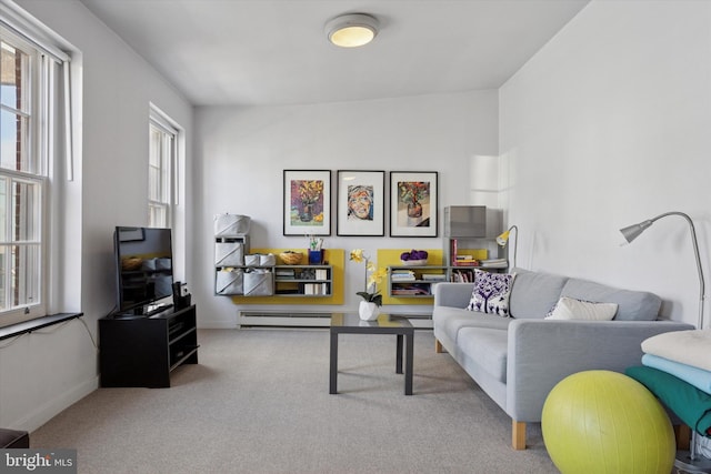 living room with a baseboard heating unit, baseboards, and carpet