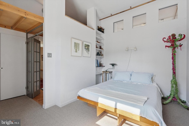 carpeted bedroom featuring baseboards