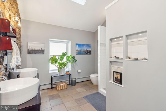 bathroom with a fireplace, lofted ceiling, baseboard heating, walk in shower, and vanity