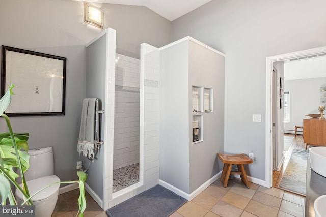 full bathroom with a baseboard radiator, baseboards, toilet, and walk in shower