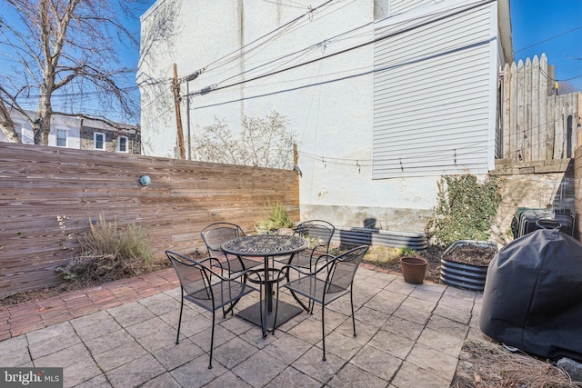 view of patio / terrace with a fenced backyard, area for grilling, and outdoor dining space