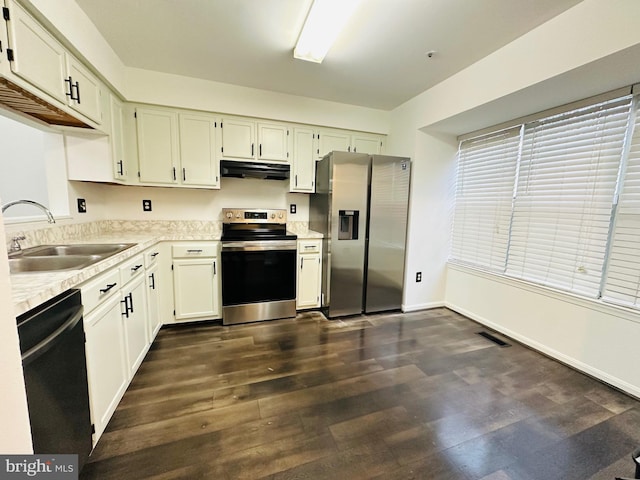 8532 Ritchboro Rd, District Heights, MD 20747 - kitchen featuring visible vents, a sink, dark wood-style flooring, appliances with stainless steel finishes, and under cabinet range hood