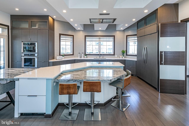 kitchen with a kitchen bar and modern cabinets