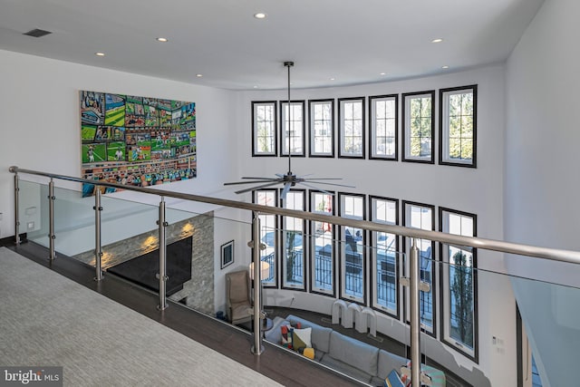 interior space with visible vents, recessed lighting, ceiling fan, and a towering ceiling