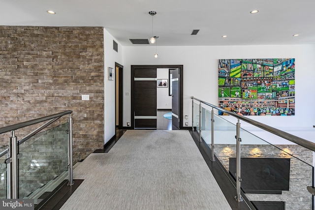 hall with an upstairs landing, recessed lighting, and visible vents